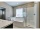 Bright bathroom features a bathtub and glass shower with white tile surround at 8487 Insignia Ave # 105, Las Vegas, NV 89178