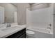 Bright bathroom with modern fixtures including white tiling, vanity, and shower-tub combo at 8487 Insignia Ave # 105, Las Vegas, NV 89178