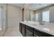 Bathroom vanity features double sinks, dark wood cabinets, and large mirror at 8487 Insignia Ave # 105, Las Vegas, NV 89178