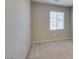 Carpeted room features a window and neutral paint creating a calm and inviting atmosphere at 8487 Insignia Ave # 105, Las Vegas, NV 89178