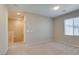 Open carpeted bedroom area features an upstairs hallway entrance, and window at 8487 Insignia Ave # 105, Las Vegas, NV 89178