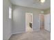 Neutral bedroom features soft carpeting and attached bathroom with easy access from open door at 8487 Insignia Ave # 105, Las Vegas, NV 89178
