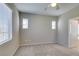 Bright bedroom features plush carpeting, ceiling fan, and natural light from large windows at 8487 Insignia Ave # 105, Las Vegas, NV 89178