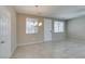 Spacious dining area with lots of light, tile floors, neutral paint colors, and access to the front door at 8487 Insignia Ave # 105, Las Vegas, NV 89178