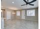Open-concept living and dining area with a ceiling fan, tile floors, and neutral paint colors at 8487 Insignia Ave # 105, Las Vegas, NV 89178