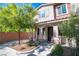Charming townhome with a well-maintained front yard and inviting covered entry with decorative stone accents at 8487 Insignia Ave # 105, Las Vegas, NV 89178