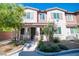 Charming townhome with a beautifully landscaped front yard and inviting covered entry with decorative stone accents at 8487 Insignia Ave # 105, Las Vegas, NV 89178