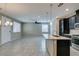 Bright kitchen features an island with granite countertop, stainless appliances and open floorplan to dining area at 8487 Insignia Ave # 105, Las Vegas, NV 89178
