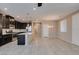 Open-concept kitchen and dining area with dark cabinets, stainless steel appliances, and tile flooring at 8487 Insignia Ave # 105, Las Vegas, NV 89178