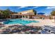 Community pool featuring ample lounge chairs and umbrellas at 8487 Insignia Ave # 105, Las Vegas, NV 89178