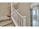 Carpeted staircase with white wooden railings and neutral walls leading to upper level at 8487 Insignia Ave # 105, Las Vegas, NV 89178