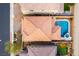 An aerial view showcases the house with a sparkling pool and jacuzzi in a private backyard oasis at 996 Cetona Ct, Henderson, NV 89011