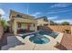 Inviting backyard with a sparkling pool, spa, covered patio, and privacy wall at 996 Cetona Ct, Henderson, NV 89011
