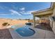 Lush backyard with a swimming pool, spa, covered patio, and manicured landscaping at 996 Cetona Ct, Henderson, NV 89011