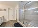 Bathroom featuring a glass-enclosed shower with white tile and a built-in bench at 996 Cetona Ct, Henderson, NV 89011