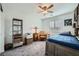 Bedroom with a ceiling fan, large window, soft carpet, and eclectic decor at 996 Cetona Ct, Henderson, NV 89011
