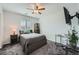 Cozy bedroom featuring a ceiling fan, large window, and plush carpeting at 996 Cetona Ct, Henderson, NV 89011