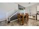 Dining area with wood-look floors, wainscoting, and a stylish table for four guests at 996 Cetona Ct, Henderson, NV 89011