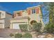 Charming two-story home featuring a tile roof, a two-car garage, and a well-manicured front yard at 996 Cetona Ct, Henderson, NV 89011