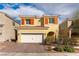 Charming two-story home featuring a tile roof, a two-car garage, and a well-manicured front yard at 996 Cetona Ct, Henderson, NV 89011