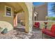 Inviting front porch with red cushioned chairs and a view of the entrance at 996 Cetona Ct, Henderson, NV 89011