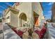 Inviting front porch with red cushioned chairs and a beautiful mosaic table at 996 Cetona Ct, Henderson, NV 89011