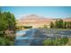 Community water feature flowing between native trees and scrub brush with scenic mountain views at 996 Cetona Ct, Henderson, NV 89011
