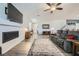 Bright living room featuring modern fireplace, large grey sofa, and grey wood-like floors at 996 Cetona Ct, Henderson, NV 89011