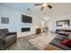 Comfortable living room features a flat-screen TV, a modern fireplace, and a grey sofa at 996 Cetona Ct, Henderson, NV 89011