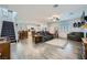An open-concept living room featuring grey wood-like flooring, a staircase, and lots of natural light at 996 Cetona Ct, Henderson, NV 89011