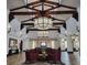 A community lobby features elegant chandeliers, beautiful wood beams, seating, and decor at 996 Cetona Ct, Henderson, NV 89011