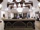 A community lobby features a large reception counter, elegant chandeliers, and beautiful decor at 996 Cetona Ct, Henderson, NV 89011