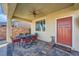 Covered patio featuring a table and chairs, conveniently located next to a red door at 996 Cetona Ct, Henderson, NV 89011