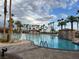 A resort-style swimming pool with palm trees, cabanas, and pristine clear blue water at 996 Cetona Ct, Henderson, NV 89011