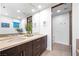 Bathroom featuring a double sink vanity and large framed mirror, along with a toilet and walk-in shower at 11441 Allerton Park Dr # 212, Las Vegas, NV 89135