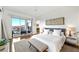 Bright bedroom featuring light gray carpet, white walls, light fixtures, and sliding glass doors to a balcony at 11441 Allerton Park Dr # 212, Las Vegas, NV 89135