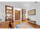 Multi-use space with hardwood floors, natural light, and glass doors along a hallway at 11441 Allerton Park Dr # 212, Las Vegas, NV 89135