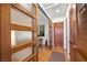 Hallway space with hardwood floors, natural light, and glass doors to another room at 11441 Allerton Park Dr # 212, Las Vegas, NV 89135