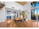 A dining area features a table, chairs, hardwood flooring, a kitchen, and access to the balcony at 11441 Allerton Park Dr # 212, Las Vegas, NV 89135