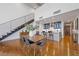 A dining area features a wooden table, chairs, hardwood flooring, a kitchen, and an open staircase at 11441 Allerton Park Dr # 212, Las Vegas, NV 89135
