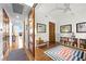 Hallway featuring hardwood floors, light fixtures, and wood doors at 11441 Allerton Park Dr # 212, Las Vegas, NV 89135