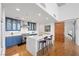 A kitchen with blue cabinetry, stainless steel appliances, hardwood flooring, and an island with a white countertop at 11441 Allerton Park Dr # 212, Las Vegas, NV 89135