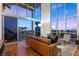 Sun-filled living room with high ceilings, hardwood floors, and access to the patio at 11441 Allerton Park Dr # 212, Las Vegas, NV 89135