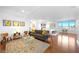A living area with a gray sofa, hardwood flooring, a rug, and a view of the city and bedroom at 11441 Allerton Park Dr # 212, Las Vegas, NV 89135