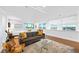 A living area with a gray sofa, hardwood flooring, a rug, and a view of the city and bedroom at 11441 Allerton Park Dr # 212, Las Vegas, NV 89135