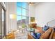 A living area with a brown leather sofa, hardwood flooring, large windows, and a view of the city at 11441 Allerton Park Dr # 212, Las Vegas, NV 89135