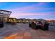 Relaxing rooftop deck with lounge seating and mountain views during a beautiful evening at 11441 Allerton Park Dr # 212, Las Vegas, NV 89135