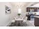 Bright dining area with a modern chandelier, seating for six, and dark wood cabinetry at 1405 Vegas Valley Dr # 247, Las Vegas, NV 89169