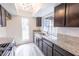 Charming kitchen features granite countertops, stainless steel sink, and dark wood cabinets at 1405 Vegas Valley Dr # 247, Las Vegas, NV 89169