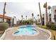 Community swimming pool surrounded by palm trees, lush landscaping, and multiple residential buildings at 1405 Vegas Valley Dr # 247, Las Vegas, NV 89169
